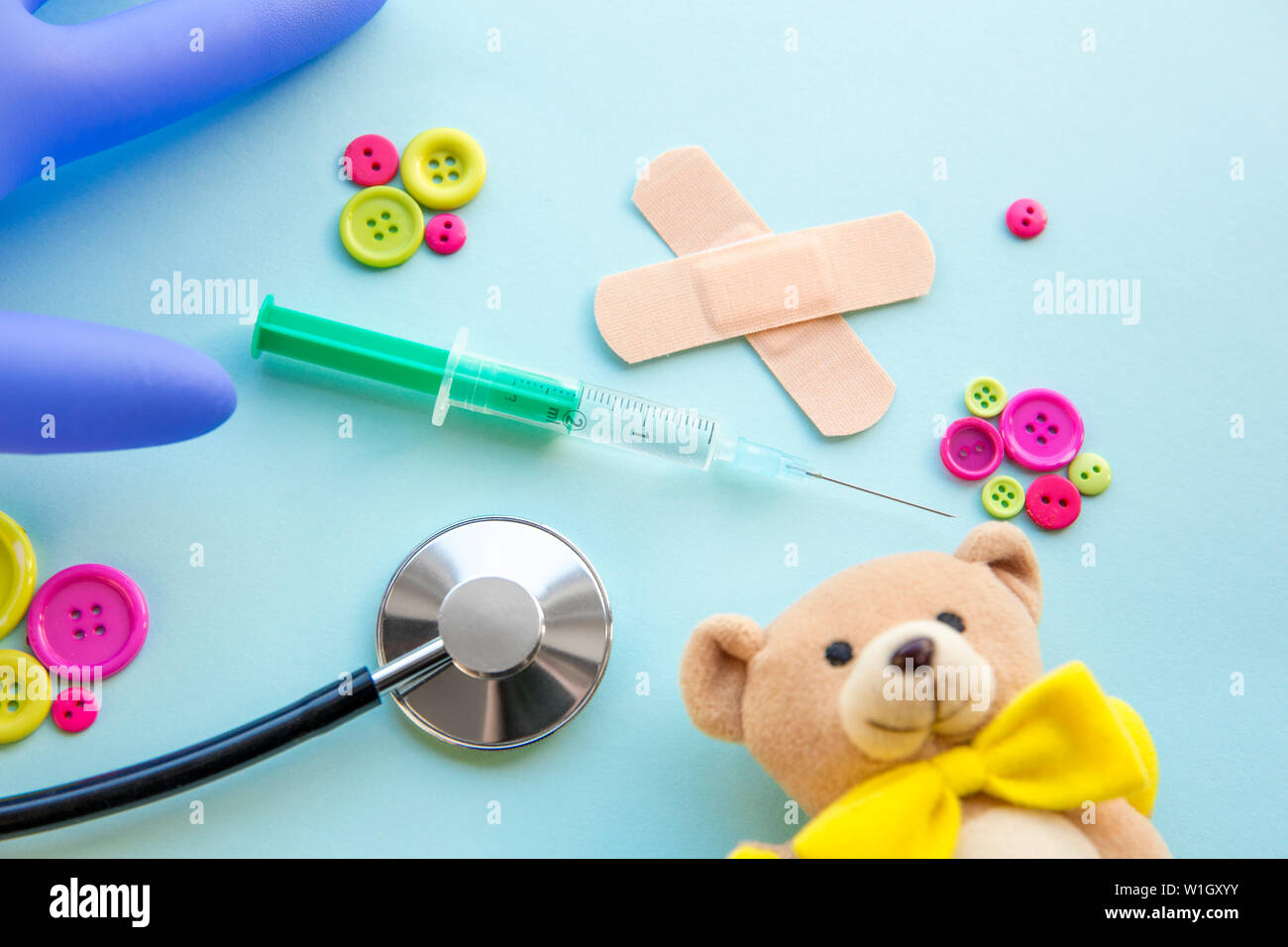 Children`s doctor appointment date number concept. Calendar with numbers, doctor, kids toys, pink and green buttons. Flat lay view. Stock Photo